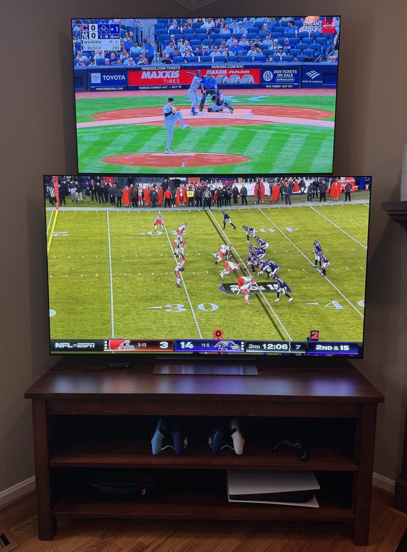 Double TV Stand in Michaels Cherry with a baseball game on the top TV and a football game on the bottom TV